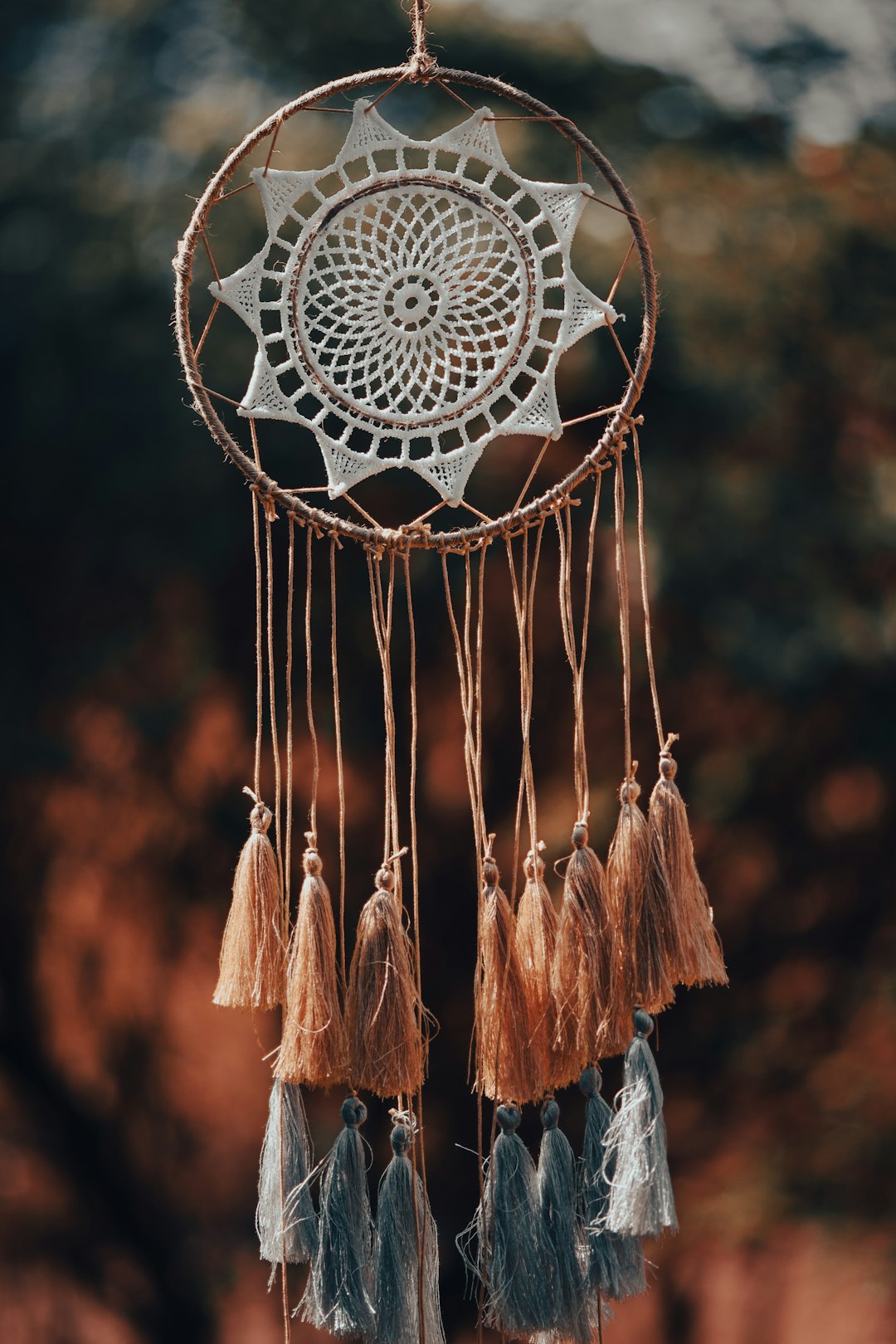 Photo by Alexas_Fotos a dream catcher hanging from a rope with tassels
